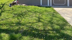 A two-story house with a garage, a front lawn, and a wooden fence. - Beautiful 3 Bed, 2 Bath, Sleeps 6, Full Kitchen. garage. Close to World cup! (Lee's Summit)