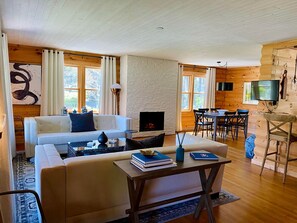 Relax in this inviting living room with a comfortable sofa, flat-screen TV, and fireplace.