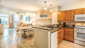 A modern kitchen with wooden cabinets, a granite countertop, and a built-in dishwasher. - Amazing Ocean View Condo Club Wyndham Ocean Blvd in N. Myrtle Beach -1 BR/1 Bath (North Myrtle Beach)