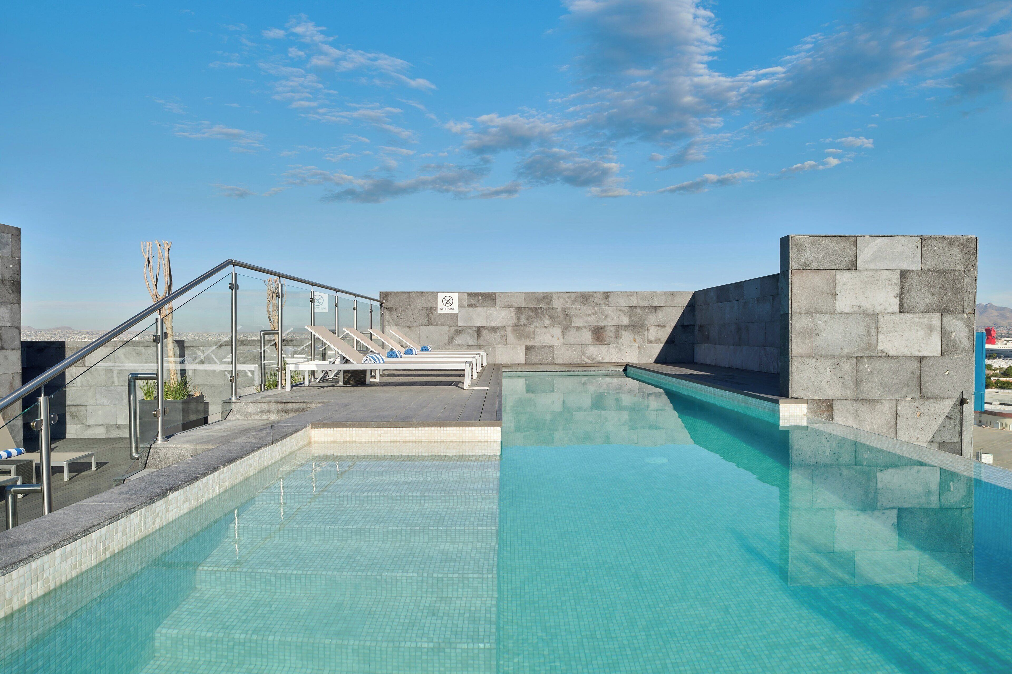 outdoor pool, open 10:00 am to 9:00 pm, pool umbrellas, pool loungers