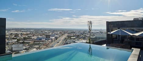 Outdoor pool, open 10:00 AM to 9:00 PM, pool umbrellas, sun loungers