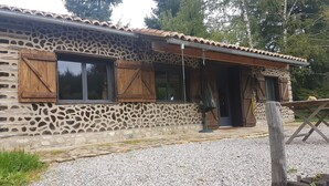 A rustic stone building with wooden shutters and a tiled roof. - Charming 1-Bed Cottage in The Hideout (La chapelle montbrandeix)