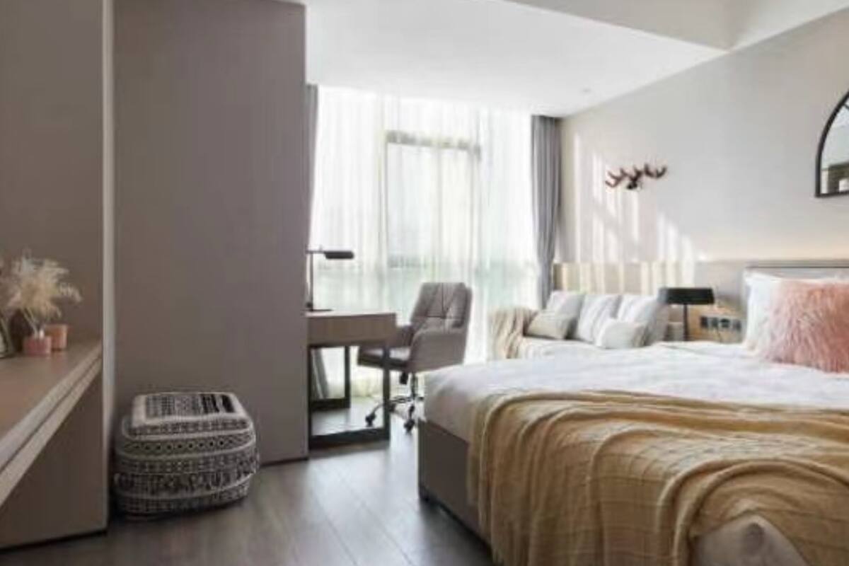 A modern bedroom with a bed, a desk, and a chair.