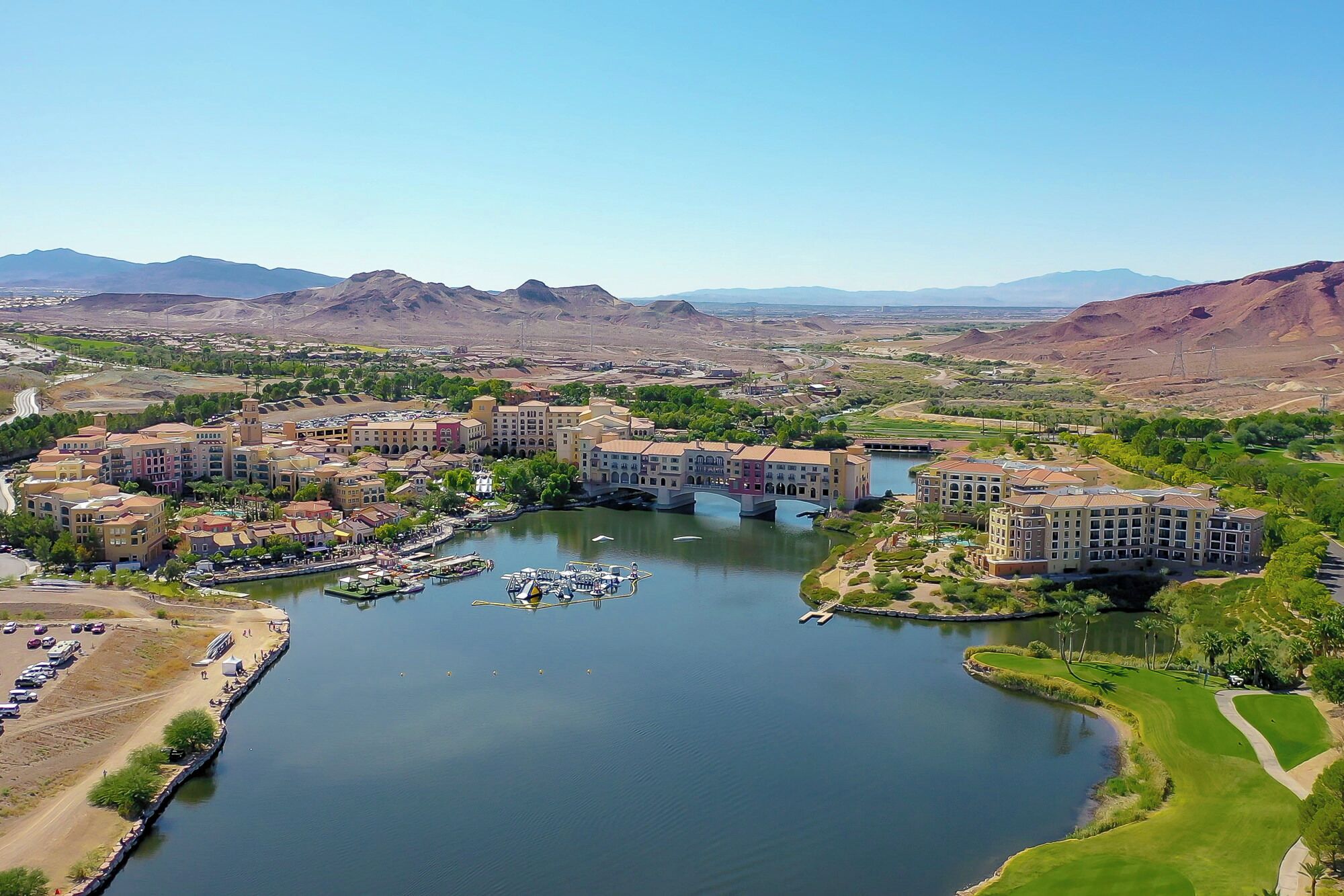 A resort with multiple buildings, a marina, and a river.