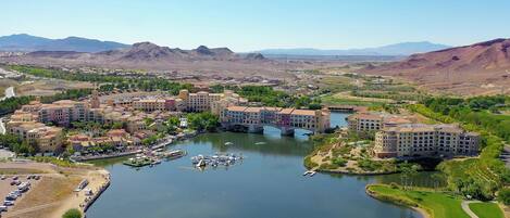 A resort with multiple buildings, a marina, and a river.