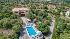 A villa with a swimming pool, outdoor seating, and a view of the surrounding countryside. - Chalet "Sa Corbaia Nova" with Mountain View, Pool, Wi-Fi, Terraces & Garden (Artà)