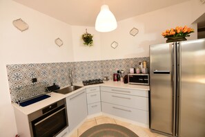 Family Apartment, 2 Bedrooms, Beach View | Private kitchen | Fridge, coffee/tea maker, electric kettle, dining tables
