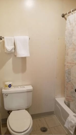Combined shower/bathtub, towels, soap, toilet paper