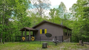 A cabin with a fenced yard, surrounded by trees. - The Bird Hallar - Cozy, quiet cabin in The Glades! (Gatlinburg)