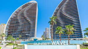 Two modern high-rise buildings with a curved facade, labeled "Sunset Waves." - Sunset Waves 18-35 Poniente Beach Resort (Benidorm)