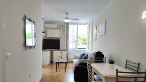 A compact living space with a kitchenette, a dining area, and a seating area with a sofa and chairs. - Best Location. Playa Las Vistas. Free Wifi (Playa de la Américas)