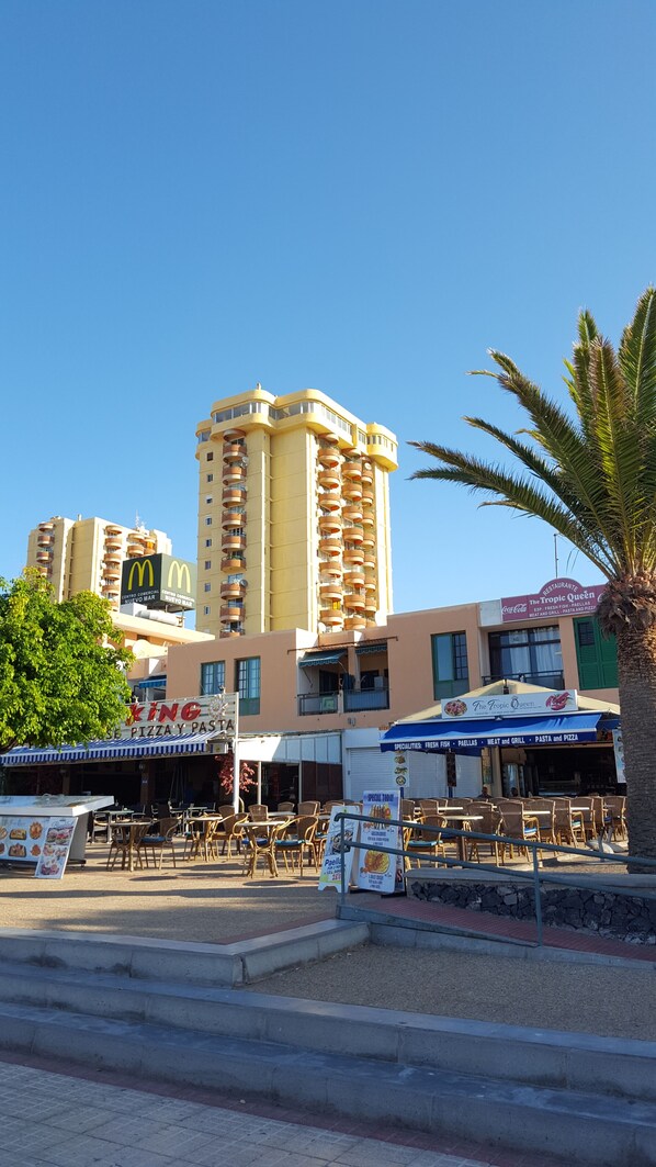 A commercial building with multiple floors, a McDonald's restaurant, and a restaurant named 'The Tropic Queen'.