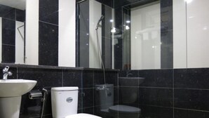 Ein modernes Badezimmer mit Toilette, Waschbecken und Dusche.