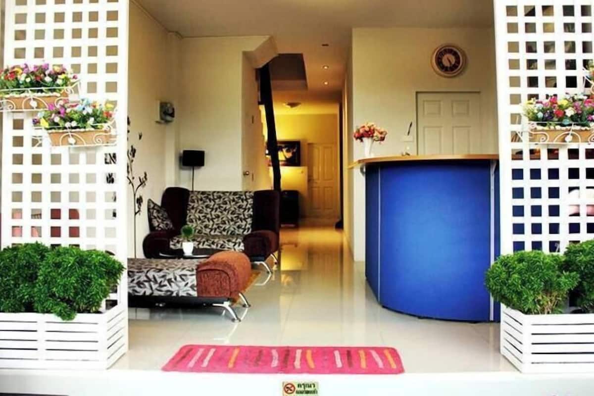 A modern living room with a sofa, a coffee table, and a blue accent wall.