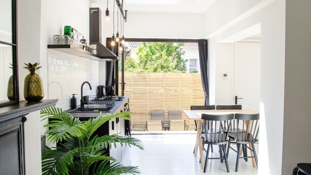 Una cocina moderna con comedor, un ventanal y vistas al exterior.