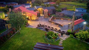 An aerial view of a village with stone buildings, a central courtyard with a well, and a small pond. - Casa da Loura - Costa da Morte (A Coruna)