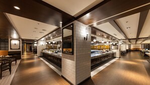 A modern hotel lobby with a central island, wooden flooring, and a mix of dark and light walls. - Hotel Metropolitan Premier Taipei (Taipei)