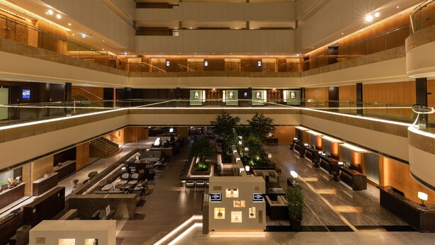 A multi-level hotel lobby with a central atrium, seating areas, and a staircase. - Hotel Metropolitan Premier Taipei (Taipei)