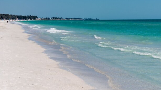A beach with clear turquoise water and white sand. - Lazy Livin 6 · Pool 50 Ft Away · 2-Min Beach (Bradenton Beach)