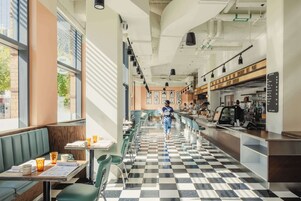 A diner with checkered flooring, booths, and a bar area.