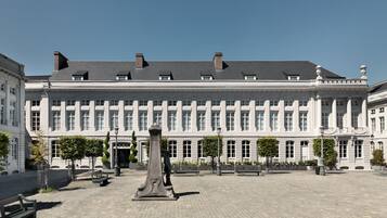 A large, historic building with a symmetrical facade, large windows, and a central entrance.