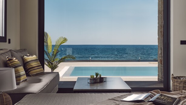 A room with a large window overlooking a pool and the sea. - Sea Front LaMer Villa,Luxury Retreat & Heated Pool (Zakynthos)
