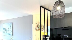 A modern kitchen with wooden cabinets, a black countertop, and a built-in dishwasher. - SEAFRONT APARTMENT VAL ANDRE ALL INCLUSIVE FOR 5 PEOPLE (Pléneuf-Val-André)