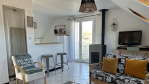 A modern living room with a sofa, armchair, and coffee table. - Le Cosy Home 3*** Apartment in house near Annecy (La Balme-de-Sillingy)