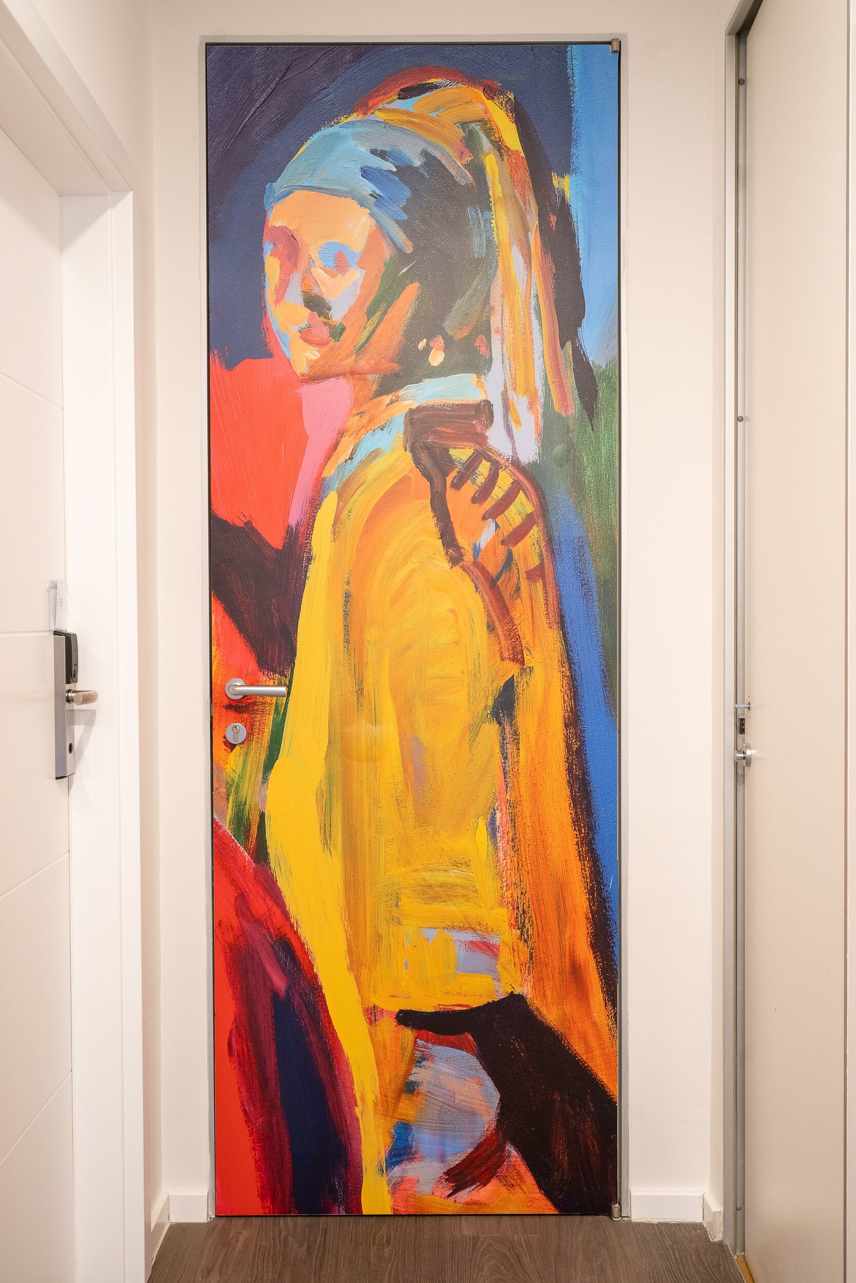 A door with a colorful abstract painting.