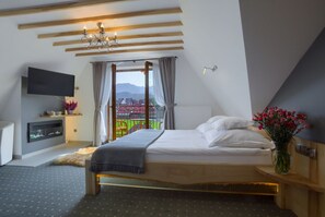 Relax in this serene bedroom with a large bed, flat-screen TV, and cozy seating area.