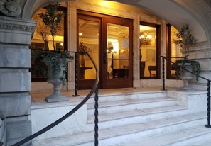 Step into a grand entrance with a majestic staircase and elegant details.