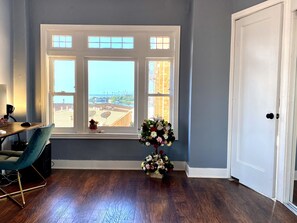 Enjoy a room with a large window offering a view of the surrounding area, a desk for work, and a comfortable seating area.