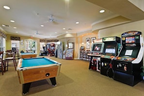 A pool table, arcade machines, and a billiards table in a room with carpeted floors and recessed lighting. - Renovated Luxury Condo in Windsor Hills Resort! 2 Miles to Disney! 3bed/2bath (Kissimmee)