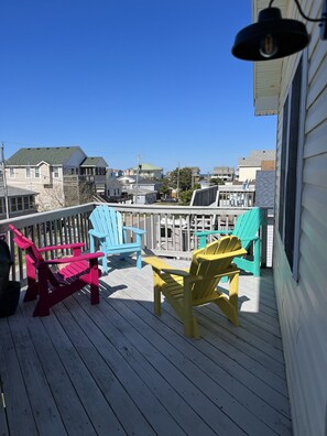 Relax in a casual outdoor seating area with Adirondack chairs and enjoy the view of the surrounding neighborhood.