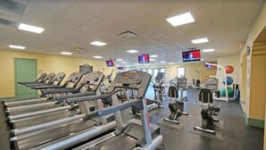 A gym with treadmills, weight machines, and exercise balls. - Hampton Hall Golf Cottage (Bluffton)