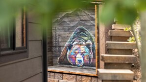 A mural of a bear on a wooden wall.
