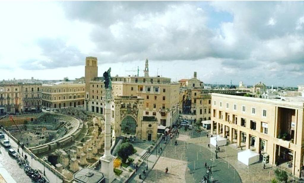 A historic building with a central courtyard, classical architecture, and a statue.