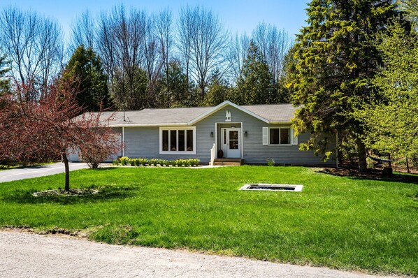 A single-story house with a front porch, a small lawn, and a tree in the foreground. - Peaceful cul-de-sac and Walking Distance to Sister Bay (Sister Bay)