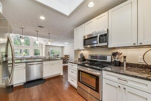 Enjoy cooking in this well-equipped kitchen with oven, microwave, and dishwasher.