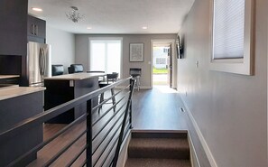 Living room with smart TV and cable. Stairway to bonus room downstairs.