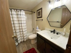 Bathtub, eco-friendly toiletries, hair dryer, towels