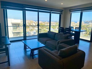 Deluxe Condo, Pool Access, City View | Living area | Smart TV
