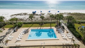 A pool area with lounge chairs and a view of the beach. - Destin Beachfront Condo | Stunning Views & Resort Amenities (Destin)