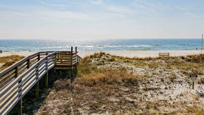 A wooden boardwalk leading to a beach with a sign indicating 'PROTECTED DUNES' and 'Please Use Walkways Only'. - Shipwatch Surf & Yacht #201B | Unobstructed Gulf Views! (Perdido Key)