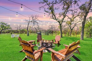A patio area with outdoor seating and a fire pit.