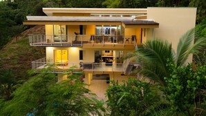 A modern two-story house with a balcony, surrounded by lush greenery. - Parrot-dise Perch, 3BD, Heart of Manuel Antonio (Quepos)