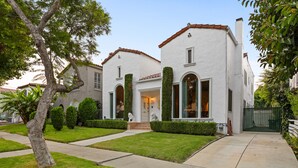A two-story house with a white exterior, red-tiled roof, and a front entrance with a set of stairs. - LOVELY RESTORED VILLA NEAR BEVERLY HILLS (Los Angeles)