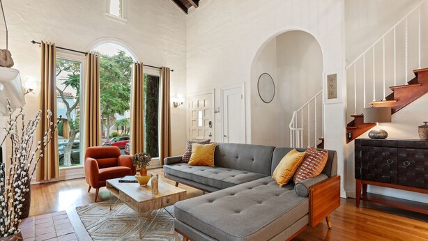 A modern living room with a sectional sofa, a coffee table, and a fireplace. - LOVELY RESTORED VILLA NEAR BEVERLY HILLS (Los Angeles)