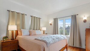 A bedroom with a bed, nightstands, a window, and curtains. - LOVELY RESTORED VILLA NEAR BEVERLY HILLS (Los Angeles)