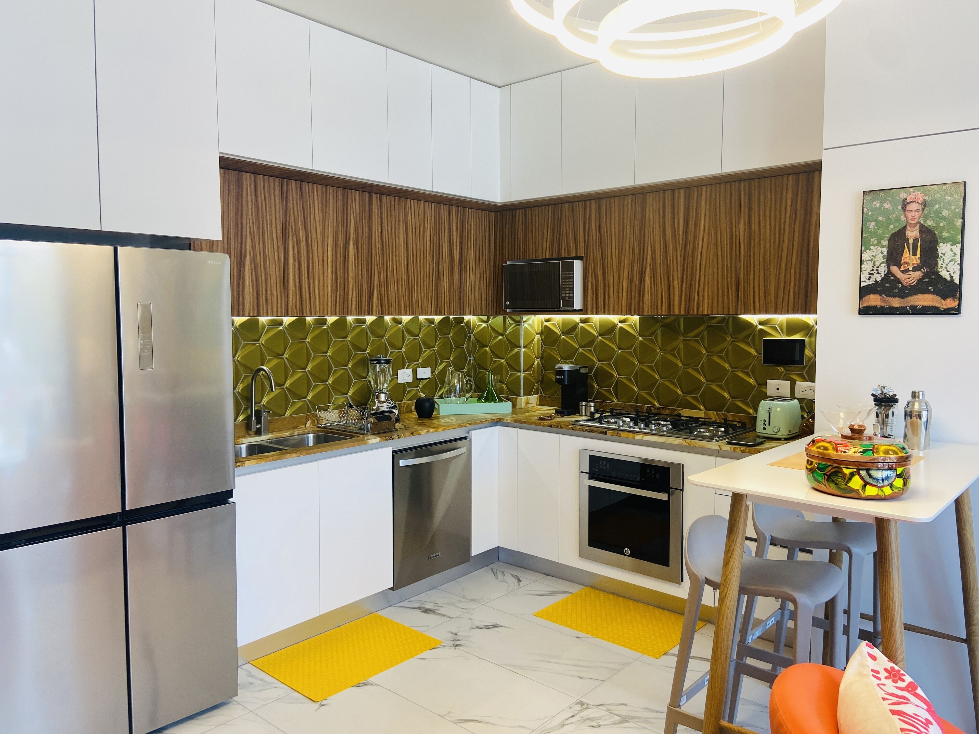 A modern kitchen with stainless steel appliances, a microwave, and a coffee maker.